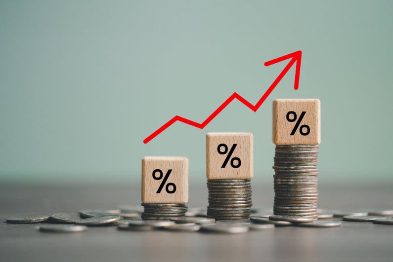 Stacks of coins with percentages going up