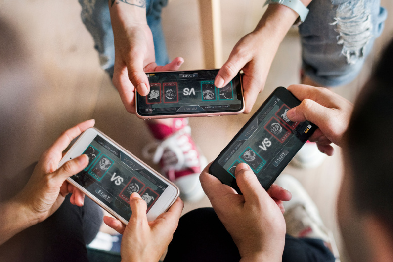 Young people playing mobile games